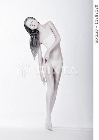 Art Bodypainting. Silhouette of Enigmatic Stylized Female Painted White 11282180