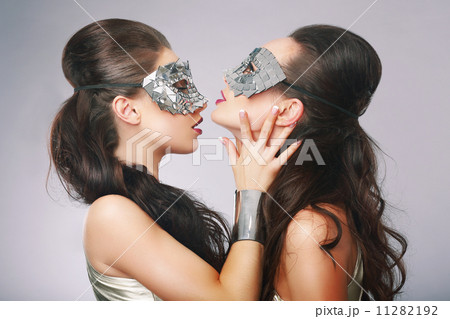 Performance. Fancy Women in Surrealistic Stylized Silver Masks 11282192