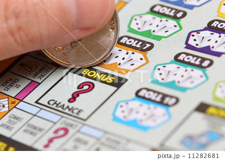 Woman scratching lottery ticket called Monopoly. 11282681