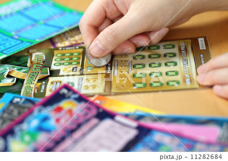 Woman scratching lottery ticket called Lucky 7 Woman scratching lottery ticket called Lucky 7 11282684