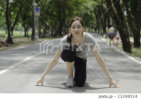 Young asian woman ready to start running on the park 11298524