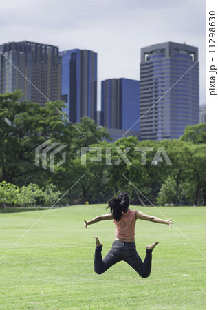 Happiness freedom concept. Woman jumping with arms up, asian bea Happiness freedom concept. Woman jumping with arms up, asian bea 11298630