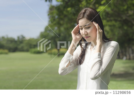Young Asian woman suffering with headache 11298656