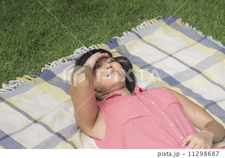 daydreaming of Asian girl in a park daydreaming of Asian girl in a park 11298687