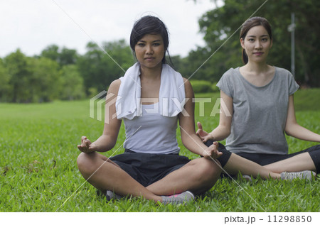 Attractive Healthy Asian Women meditating in the park 11298850