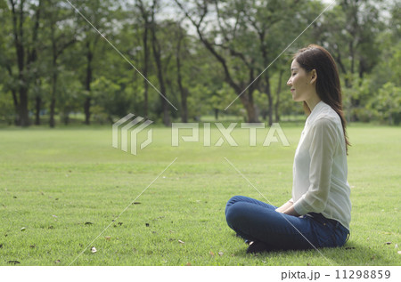 Attractive Healthy Asian Woman meditating in the park 11298859