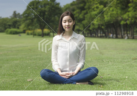 Attractive Healthy Asian Woman meditating in the park 11298918