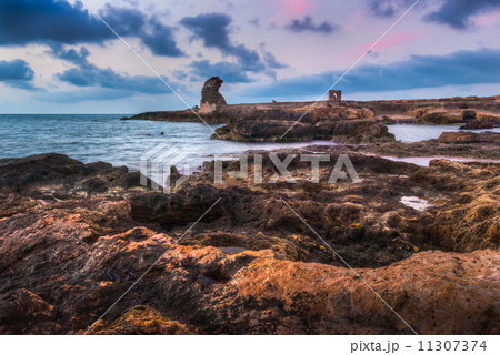 rocky beach with ancient ruins 11307374