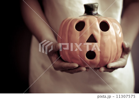 a child holds the pumpkin a child holds the pumpkin 11307575