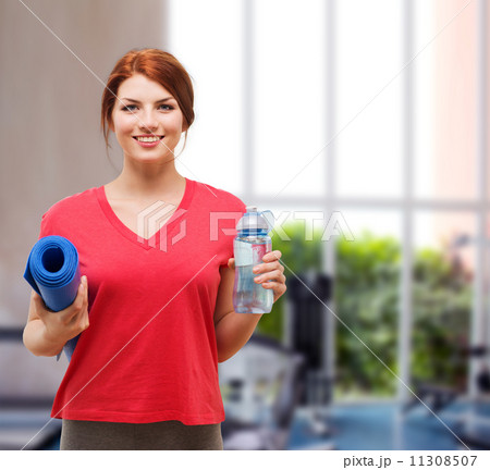 smiling girl with bottle of water after exercising 11308507