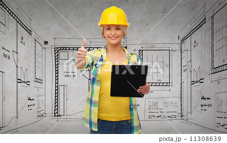 smiling woman in helmet with clipboard smiling woman in helmet with clipboard 11308639