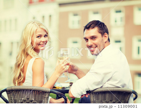 smiling couple drinking wine in cafe smiling couple drinking wine in cafe 11309001