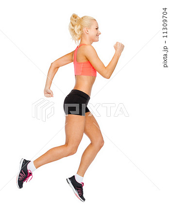 sporty woman running or jumping sporty woman running or jumping 11309704