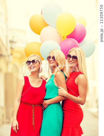 beautiful girls with colorful balloons in the city 11309750