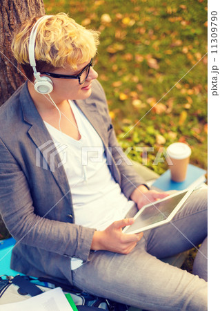 smiling male student in eyeglasses with tablet pc 11309790