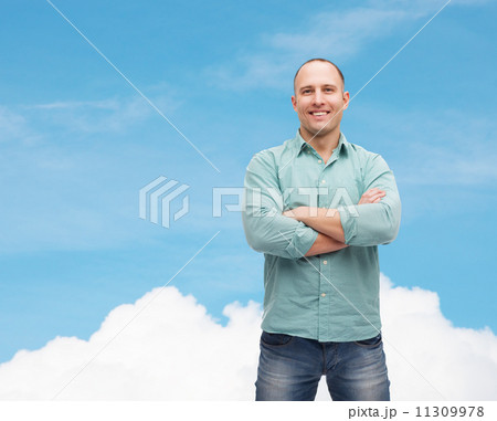 smiling man with crossed arms 11309978