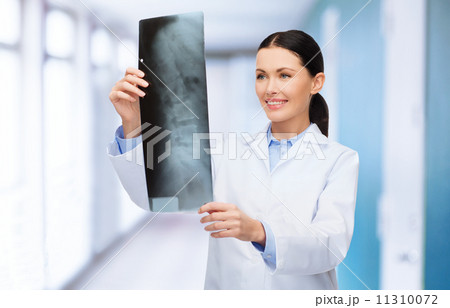 smiling female doctor looking at x-ray 11310072