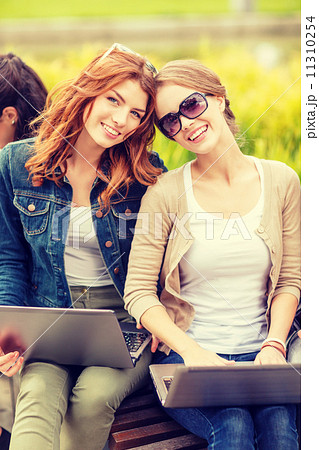 two female students with laptop computers 11310254
