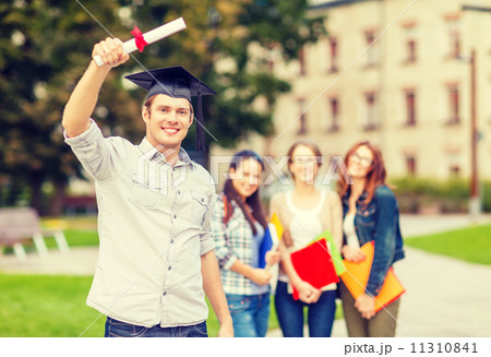 smiling teenage boy in corner-cap with diploma smiling teenage boy in corner-cap with diploma 11310841
