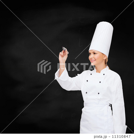 smiling female chef writing something on air 11310847