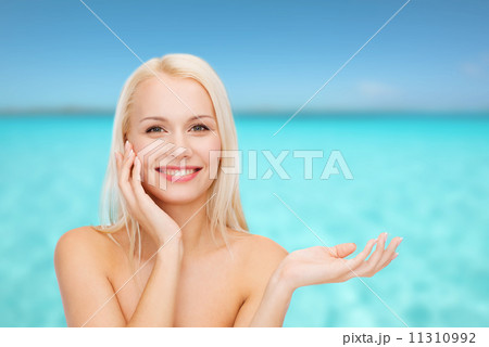 smiling woman holding imaginary lotion jar smiling woman holding imaginary lotion jar 11310992