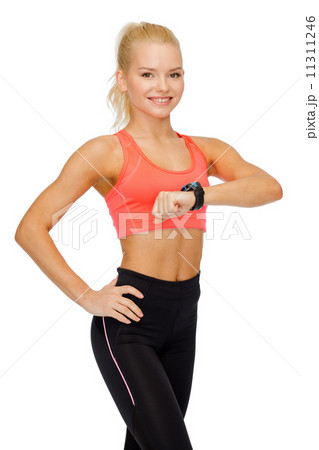 smiling woman with heart rate monitor on hand smiling woman with heart rate monitor on hand 11311246