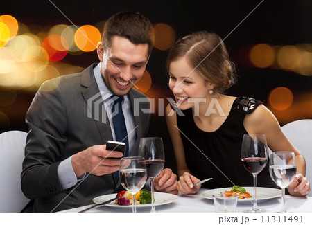 smiling couple eating main course at restaurant smiling couple eating main course at restaurant 11311491