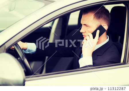 man using phone while driving the car man using phone while driving the car 11312287