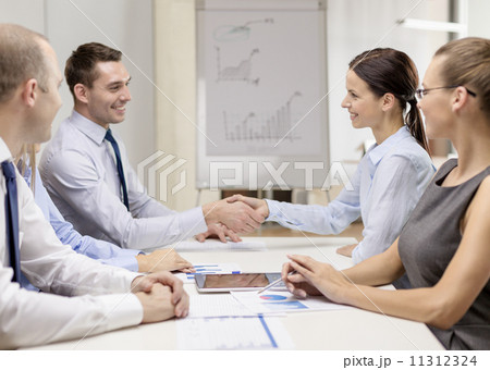 businessman and businesswoman shaking hands businessman and businesswoman shaking hands 11312324