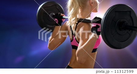 sporty woman exercising with barbell from back sporty woman exercising with barbell from back 11312599