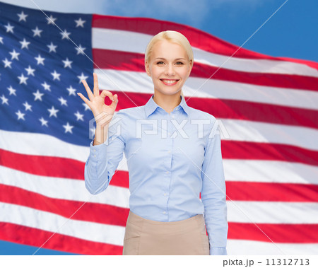 smiling businesswoman showing ok-sign with hand smiling businesswoman showing ok-sign with hand 11312713
