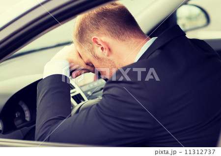 tired businessman or taxi car driver 11312737