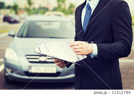 man with car documents outside man with car documents outside 11312789