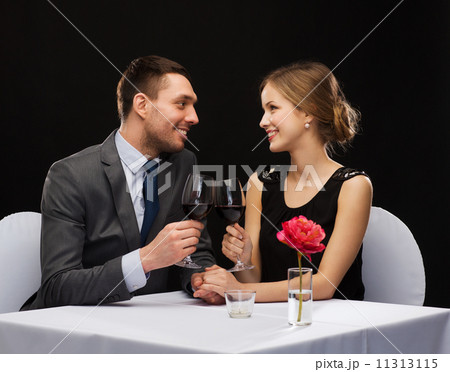 young couple with glasses of wine at restaurant young couple with glasses of wine at restaurant 11313115