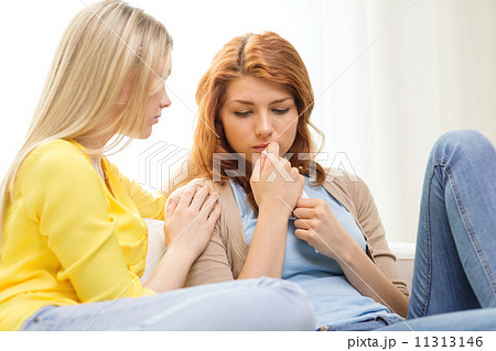 one teenage girl comforting another after break up one teenage girl comforting another after break up 11313146