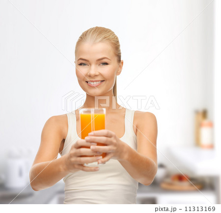 smiling woman holding glass of orange juice smiling woman holding glass of orange juice 11313169
