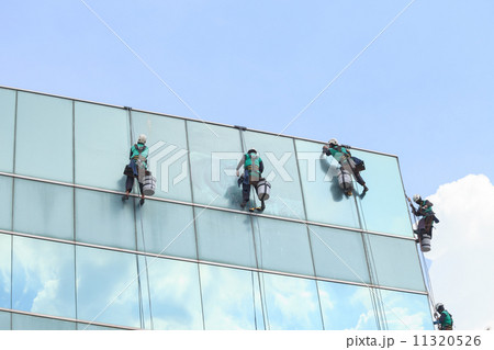 group of workers cleaning windows service on high rise building group of workers cleaning windows service on high rise building 11320526