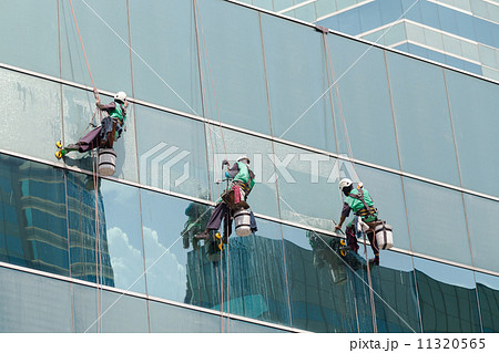 group of workers cleaning windows service on high rise building group of workers cleaning windows service on high rise building 11320565