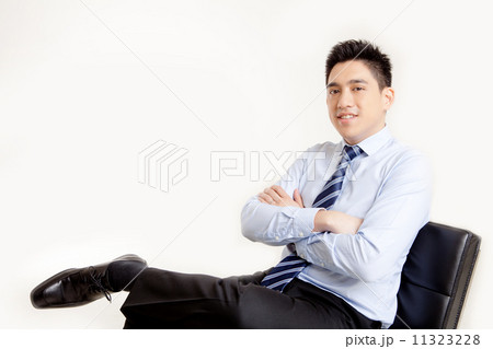 Businessman Sitting with Arms Crossed Businessman Sitting with Arms Crossed 11323228
