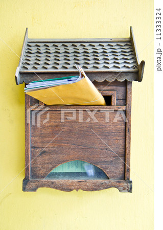Cloes up of a wooden mailbox in front of home Cloes up of a wooden mailbox in front of home 11333324