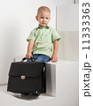sad kid with briefcase on stairs 11333363