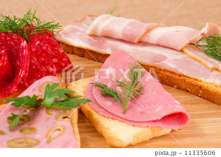 Sandwiches with salami, bacon and mortadella 11335606