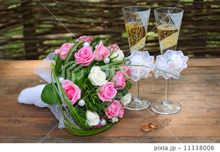 a wedding bouquet is glasses and rings 11338006