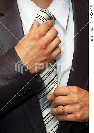 man hands remedying tie 11338319