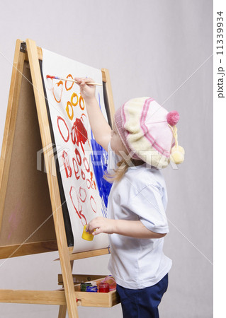Girl artist paints on canvas 11339934