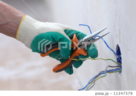 worker puts the wires worker puts the wires 11347379