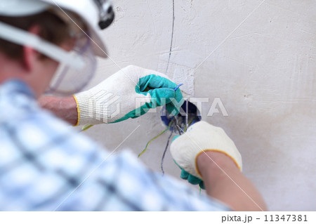 worker puts the wires worker puts the wires 11347381