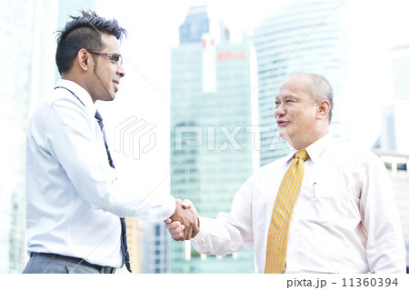 Multi-racial business executive handshake Multi-racial business executive handshake 11360394