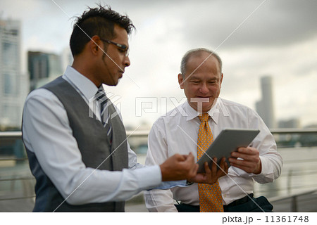Businessman having discussion using tablet Businessman having discussion using tablet 11361748