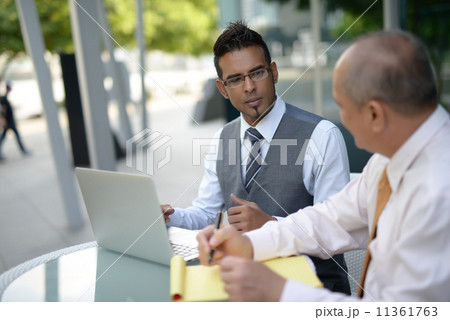 Businessman having discussion using computer Businessman having discussion using computer 11361763